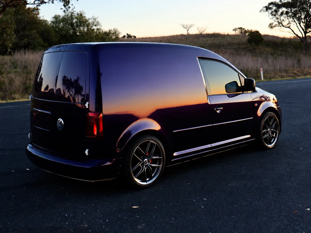 The Need for Studio mobile detailing van — a dark Volkswagen Caddy parked at sunset