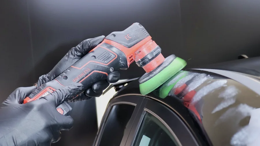 Need for Studio running a compact dual-action polisher along a roof edge