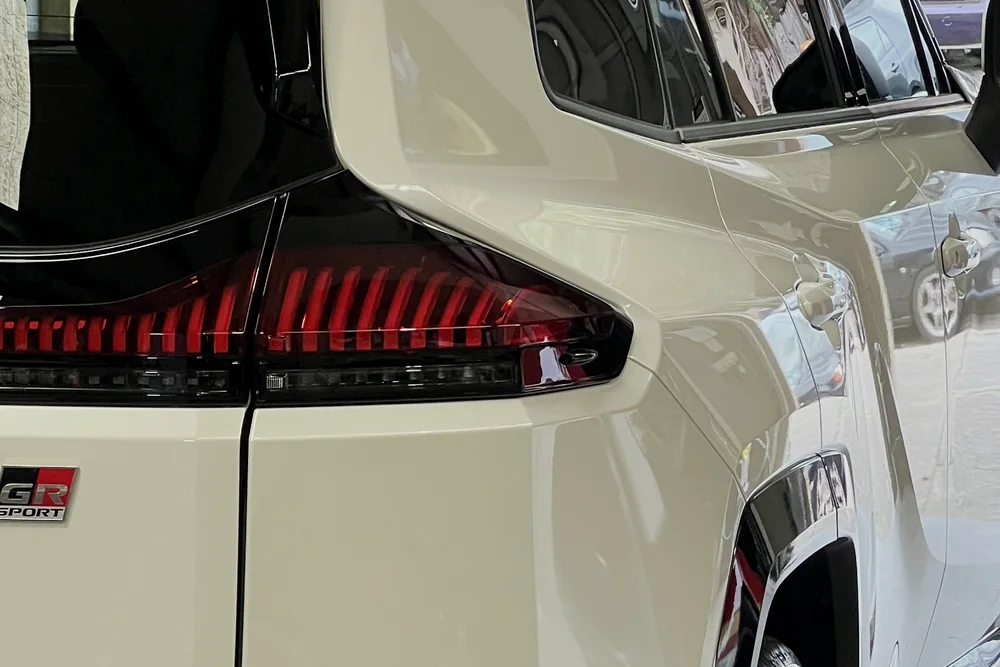 Rear quarter panel of a white Toyota RAV4 GR Sport reflecting light after ceramic coating